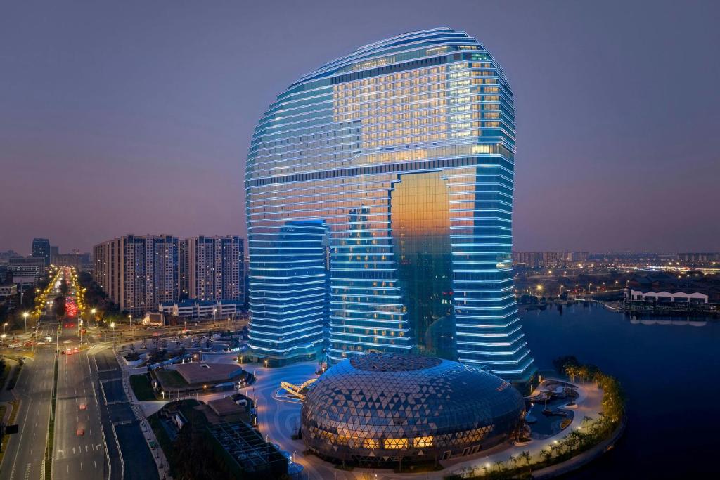 a large glass building with a dome in front of it at Huzhou Marriott Hotel Nanxun in Huzhou