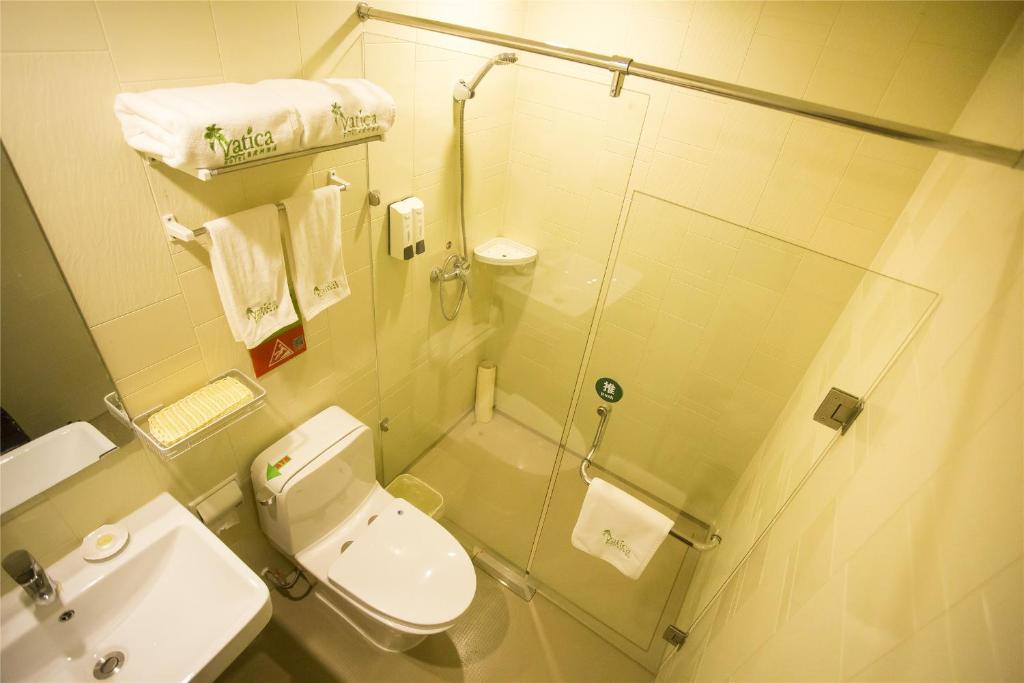 ein Bad mit einer Dusche, einem WC und einem Waschbecken in der Unterkunft Vatica Anhui Hefei South High Speed Rail Station Susong Road Hotel in Hefei
