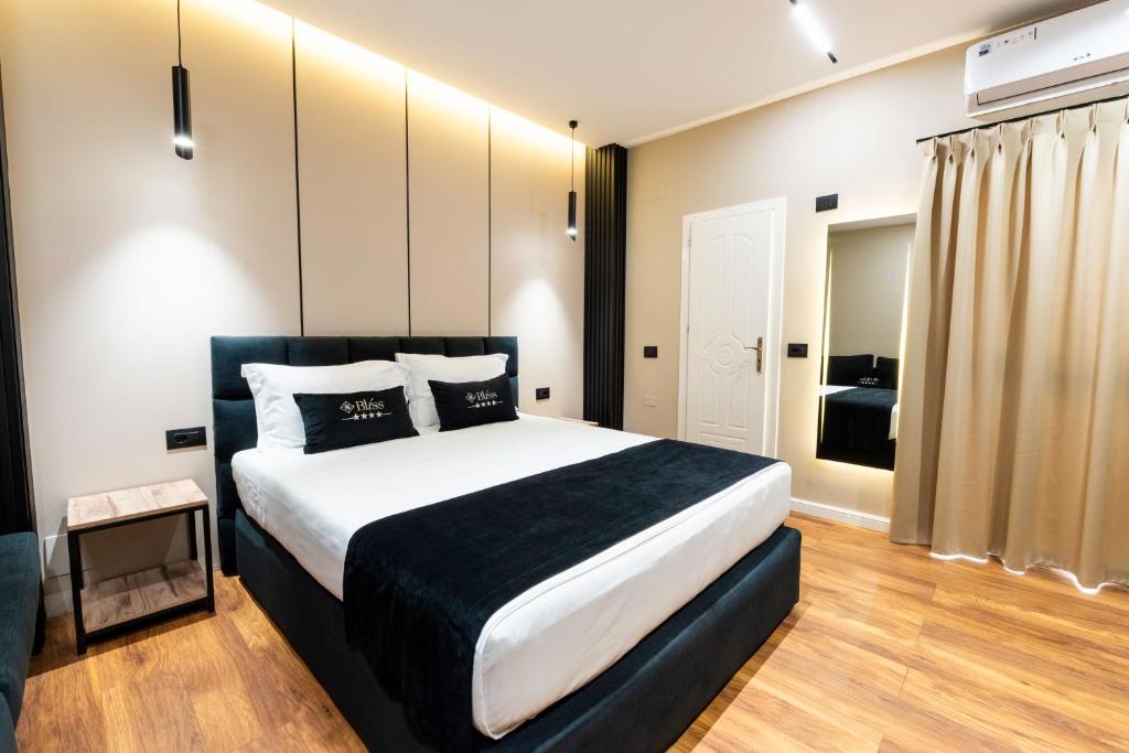 a bedroom with a large bed in a room at Bliss Boutique Hotel in Durrës