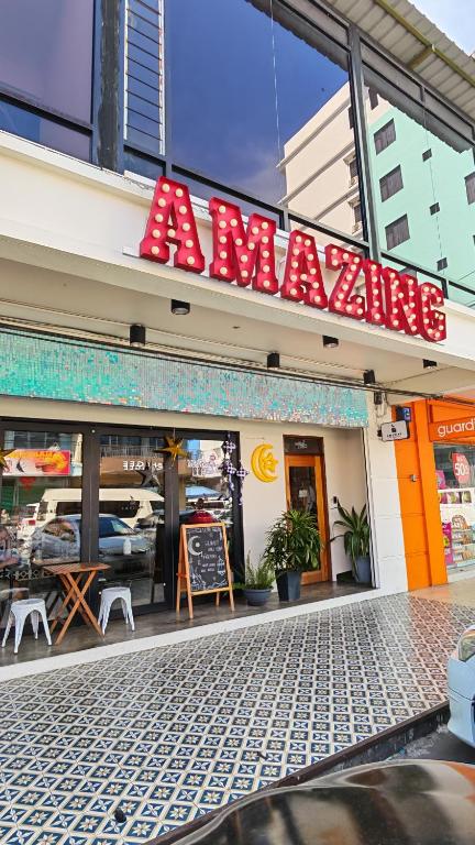 a restaurant with a sign on the front of it at Amazing Rooms in Semporna