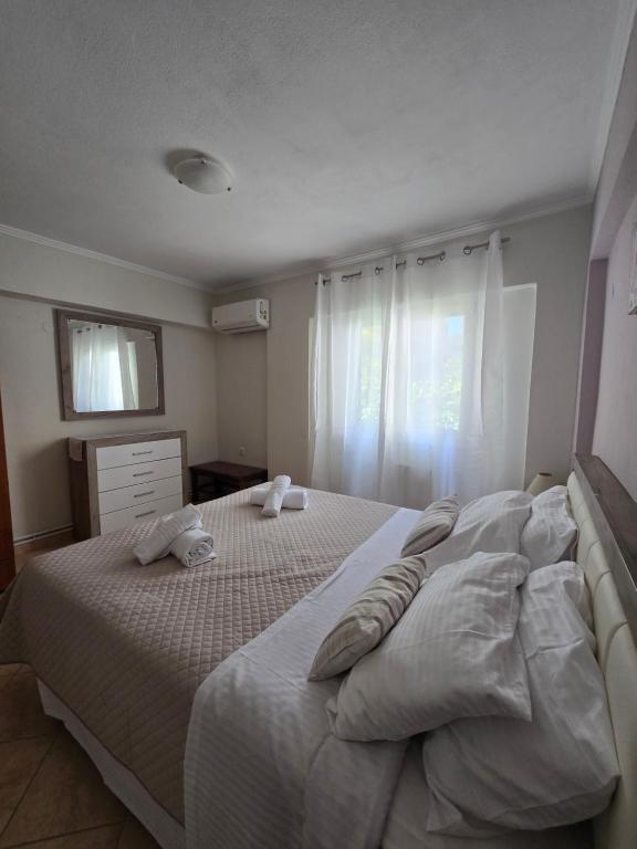 a bedroom with two beds with pillows on them at Dimitris House Petriti in Petrití