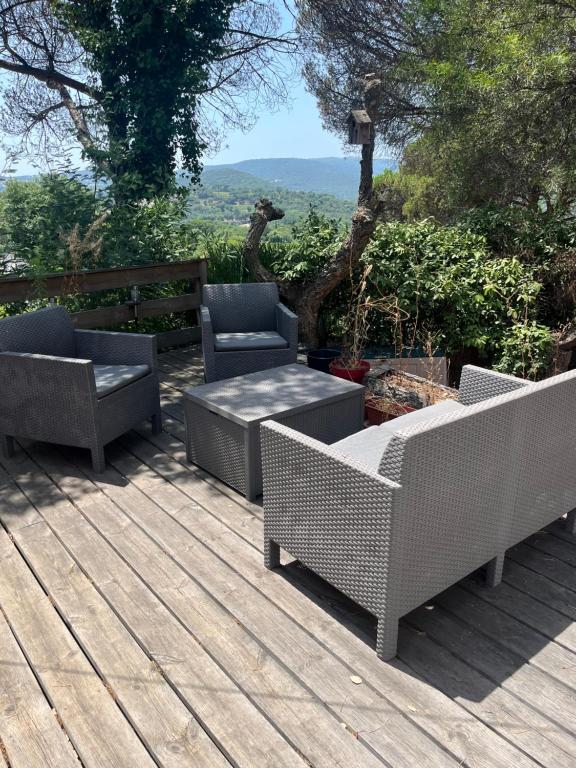 a patio with two chairs and a table on a deck at Mobile-home in Gassin