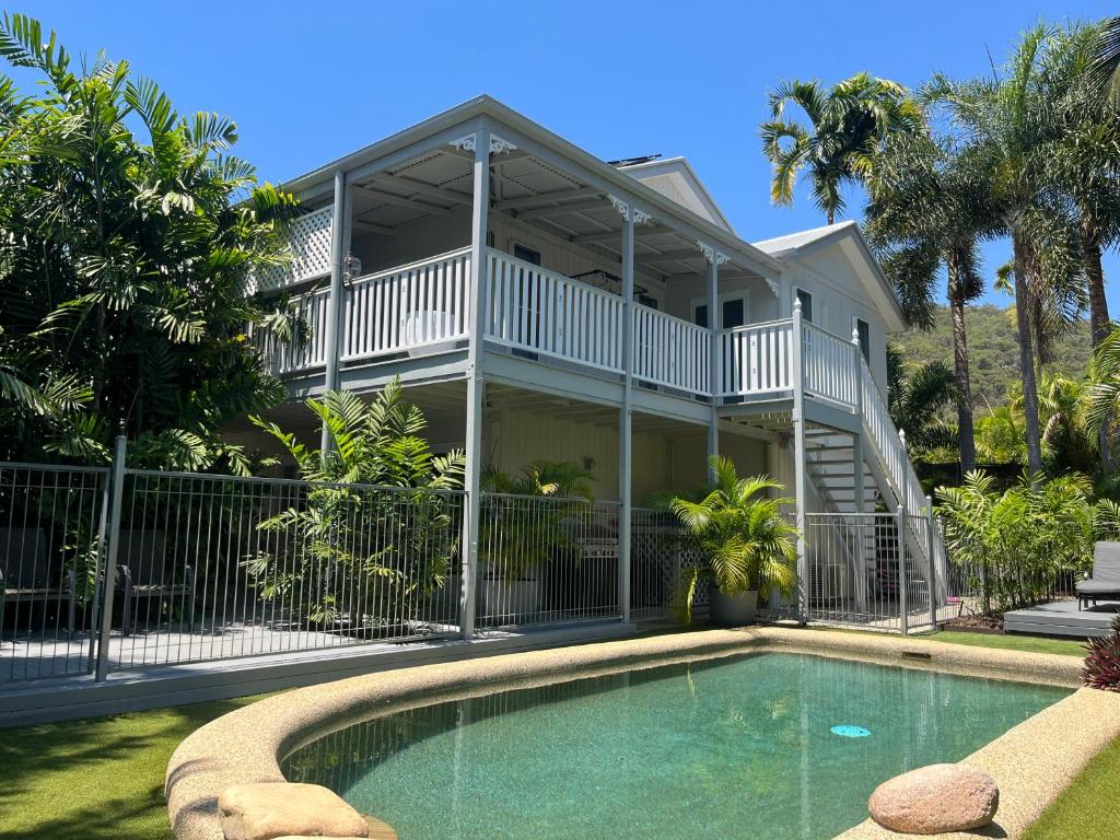 a house with a swimming pool in front of a house at Somerset Palms Studio Apartment in Horseshoe Bay
