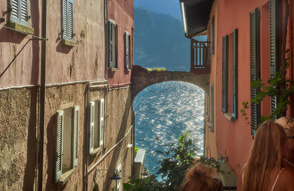 a view of the ocean from between two buildings at Casa di Mezzo "Historic centre of VARENNA" Lake Como in Varenna