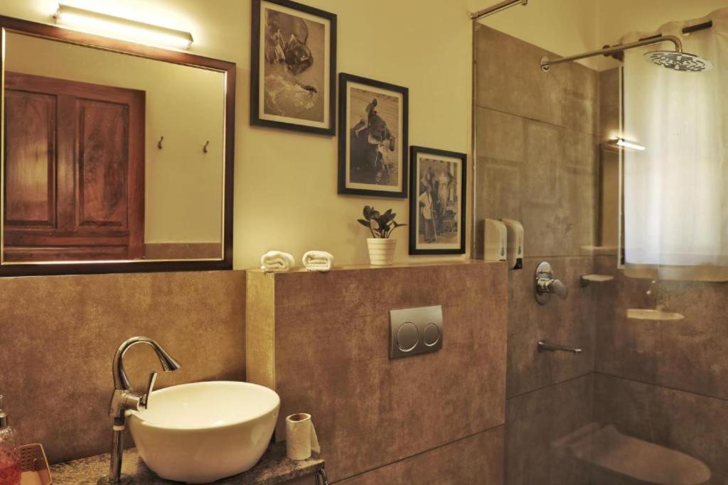 a bathroom with a tub and a sink and a shower at halo in Ahangama