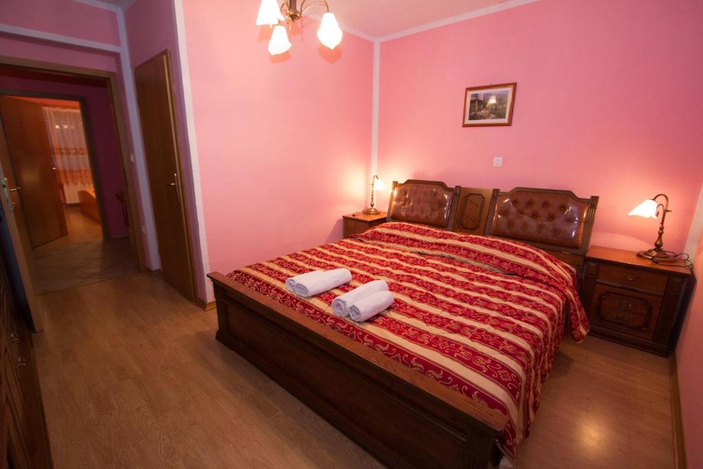 a bedroom with a bed with two towels on it at Tourist Farm Gregorič in Zalošče