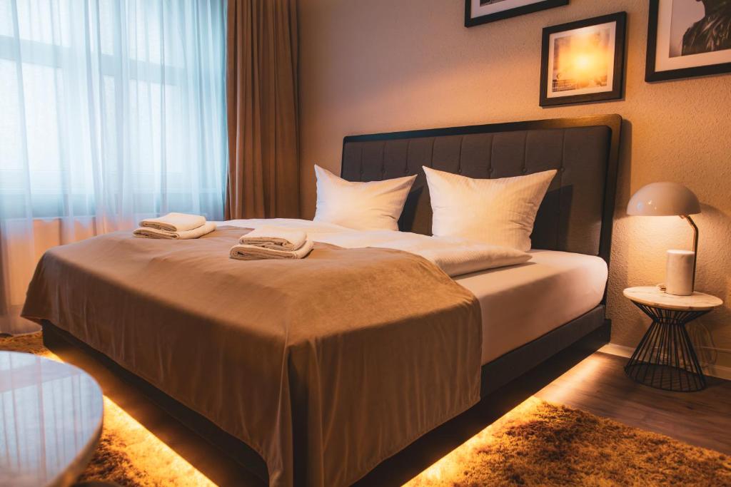 a bedroom with a bed with two towels on it at Cityloft Erfurt in Erfurt