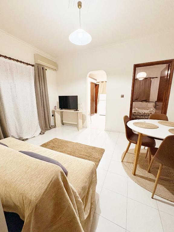 a hotel room with two beds and a table at Gorgyra - Boutique Apartment in Karlovasi
