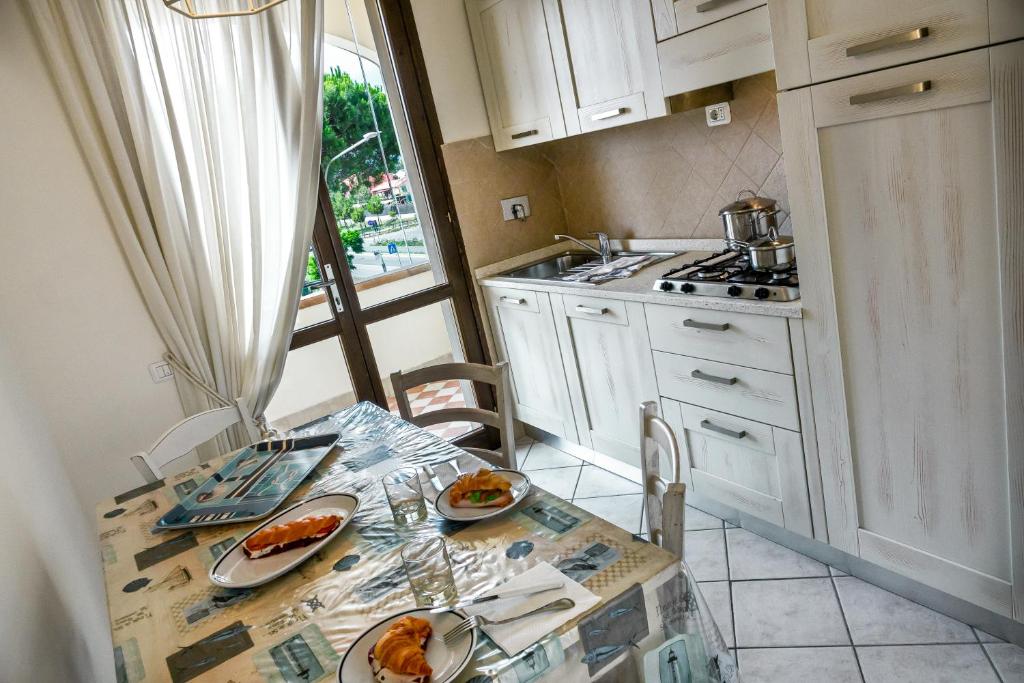 a kitchen with a table with plates of food on it at Villetta Tina in Vada