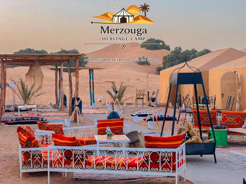 a group of chairs and tables in the desert at Merzouga heritage camp in Merzouga
