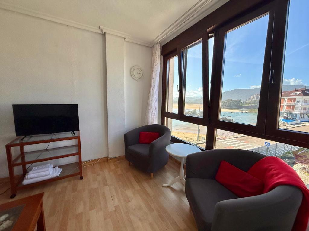a living room with a television and a couch and a chair at Perez del Molino - 5806 in Isla