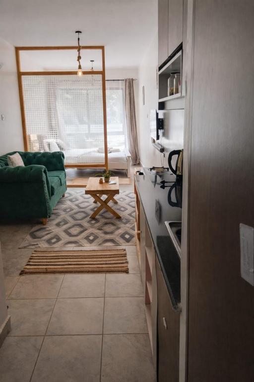 a kitchen and living room with a green couch at Bohen BnB 1 in Ongata Rongai 