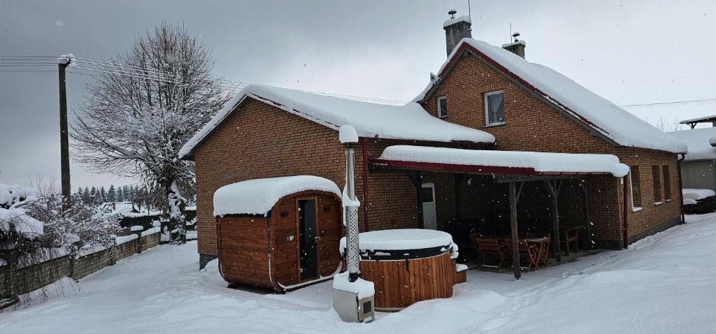 a house with snow on the roof of it at Chata Lipa in Trstená