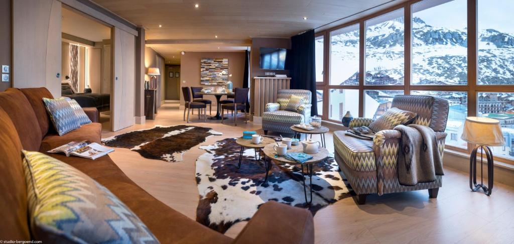 a living room with a couch and chairs and a table at Le Taos in Tignes