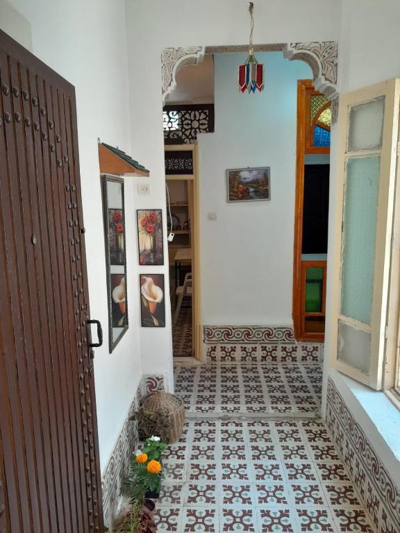 a hallway with a door and a tile floor at dar rachid in Fez