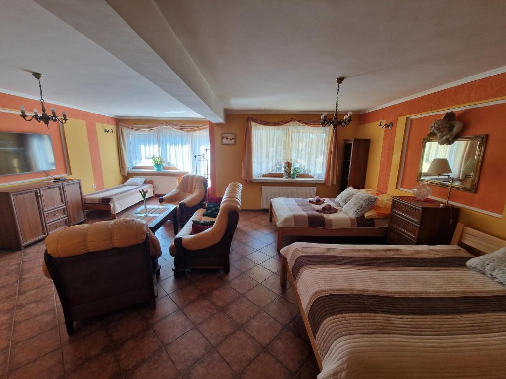 a living room with two beds and a couch at Apartament Fort Owcza Góra in Kłodzko