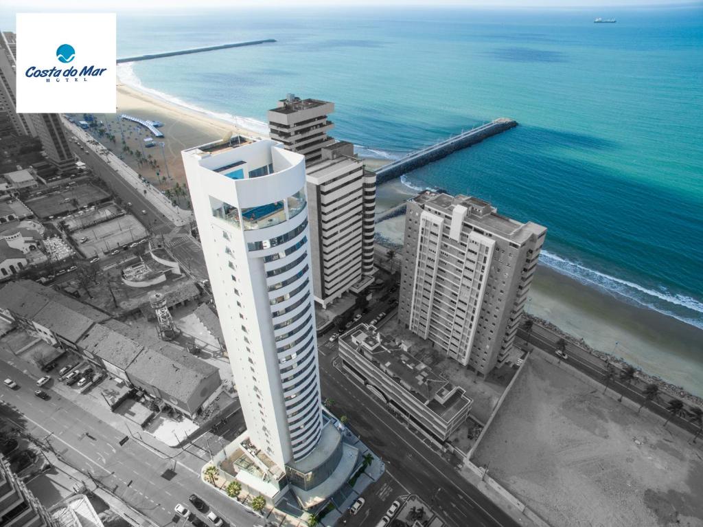 an aerial view of a tall building next to the ocean at Costa do Mar Hotel in Fortaleza