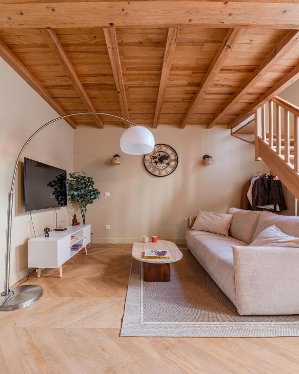 a living room with a couch and a table at La parenthèse lilloise in Lille