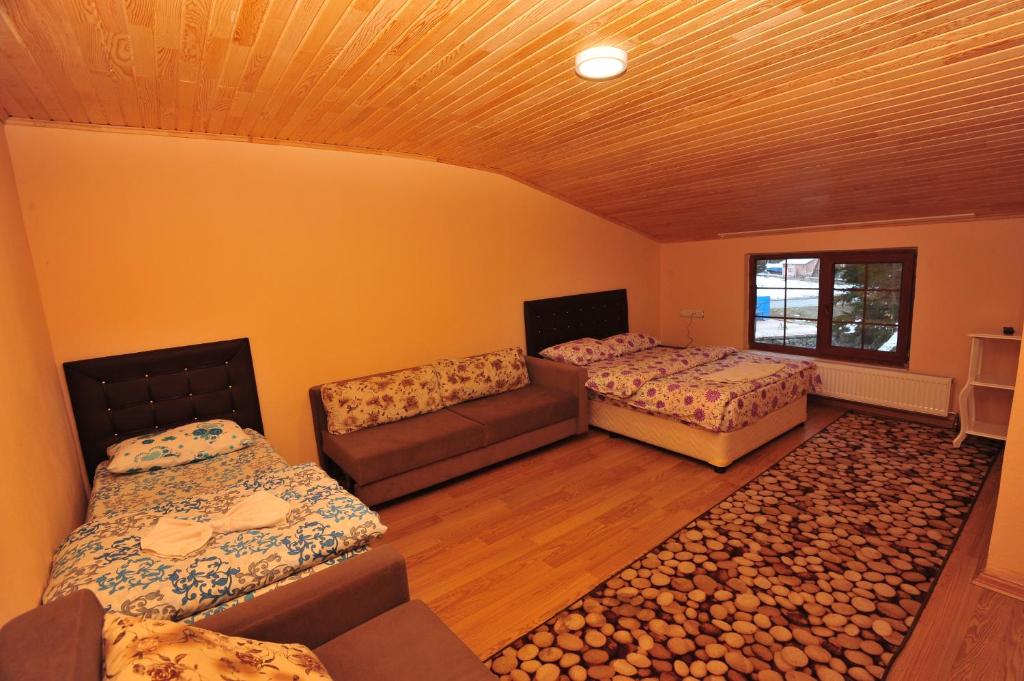 a room with two beds and a couch in it at Cam Hotel & Restaurant 2 in Uzungöl