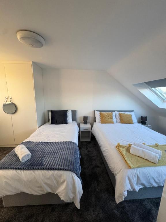 two beds sitting next to each other in a room at London Heathrow Uxbridge Escape in Uxbridge