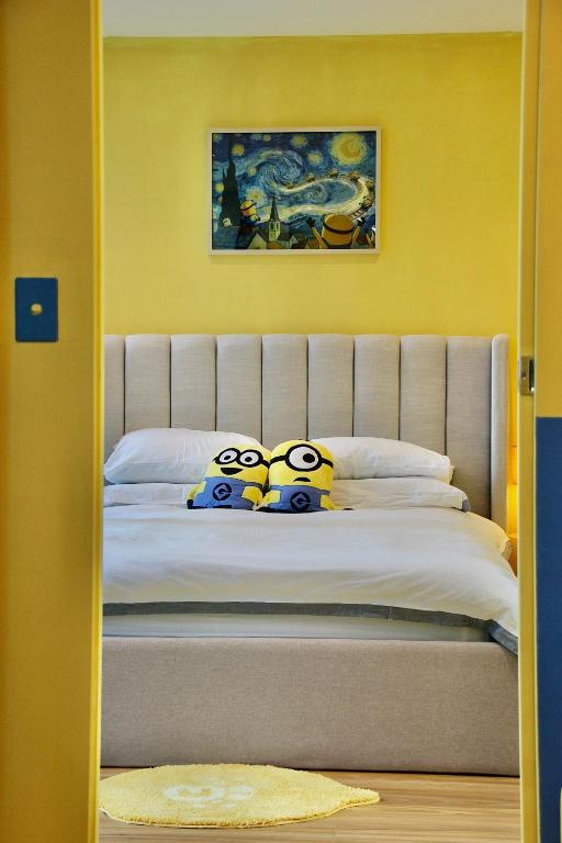 a bedroom with a bed with three angry pillows at Banana Bliss - Spacious 2 Bedroom CBD Apartment with 2 Balconies, 2 Bathrooms & Parking Option in Melbourne