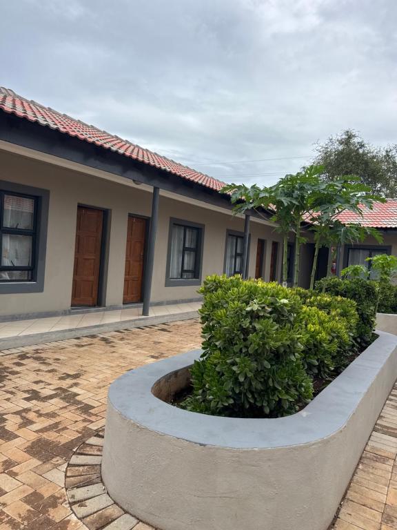 a building with a circular planter in front of it at Northam Square Mine Contractor Accommodation in Northam