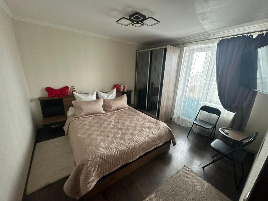 a bedroom with a bed and a ceiling fan at Apartment in Zolotonosha