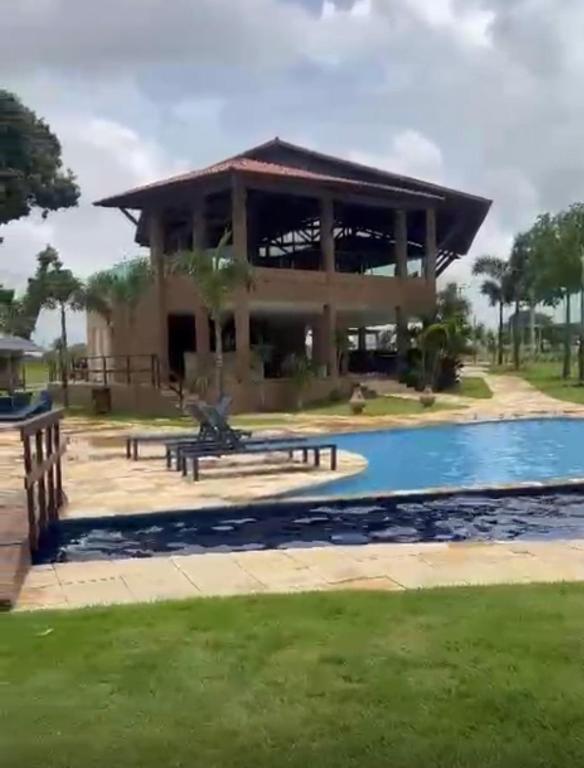 a large building with a swimming pool in front of it at Day Use in Cascavel