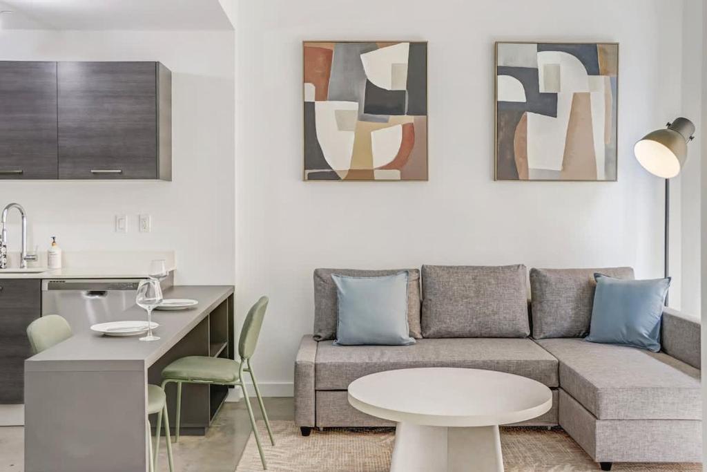 a living room with a couch and a table at Downtown Miami Condo with Balcony & Rooftop Pool in Miami