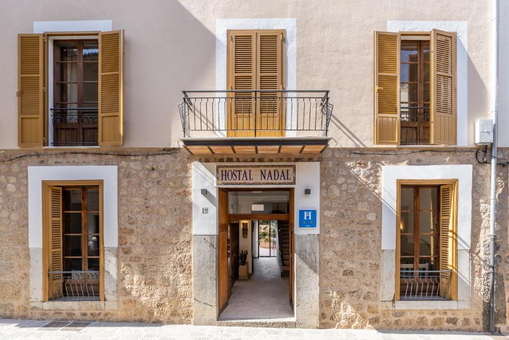 a building with a sign that reads french museum at Hostal Nadal in Sóller