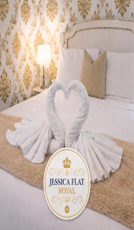 two towels in the shape of two swans on a bed at Jessica Flat Malta Royal Guesthouse in Cospicua