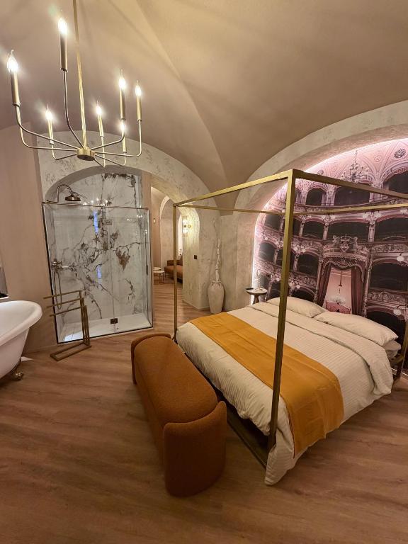 a bedroom with a canopy bed and a tub and a sink at La Maison Du Theatre in Catania