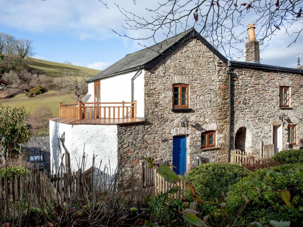 an old stone house with a blue door at Tuckenhay, 4 Castle Cottage- Fcn in Ashsprington