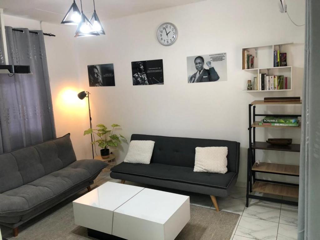 a living room with a couch and a coffee table at Studio 1 chambre in Port-Gentil