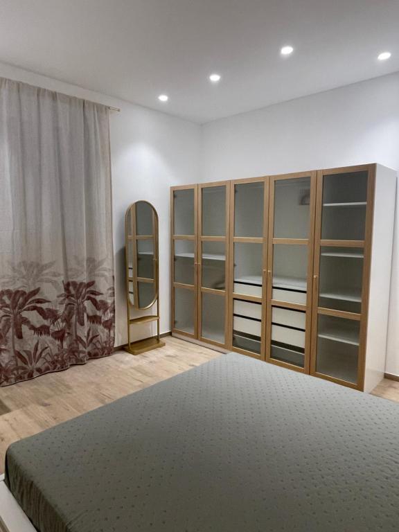 a bedroom with a large bed and a mirror at Credo Mare Luxury Stay - Comfort in Pescara