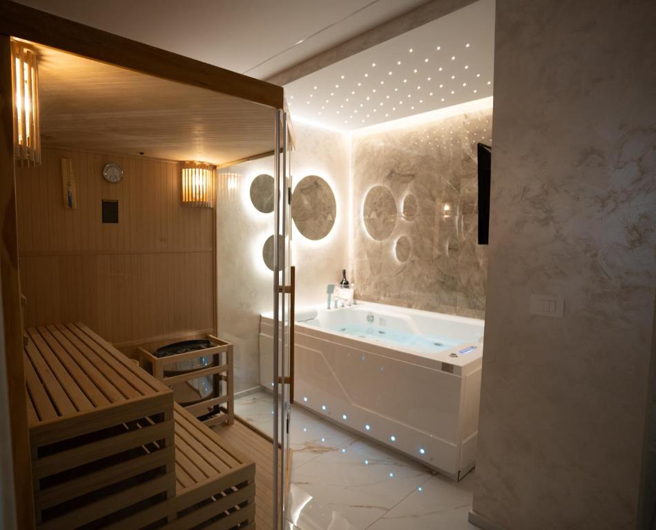 a large bathroom with a tub and a shower at Elysium suites & Spa in Barletta