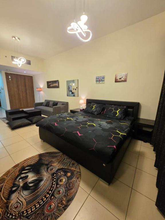 a large bedroom with a bed and a couch at Ajman Beach View AIO4OO7 in Ajman 
