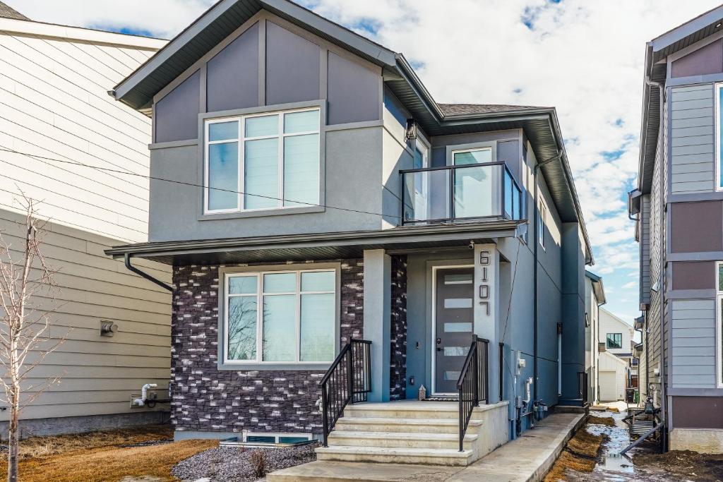 a house with a blue and gray facade at Executive Basement suite in Edmonton