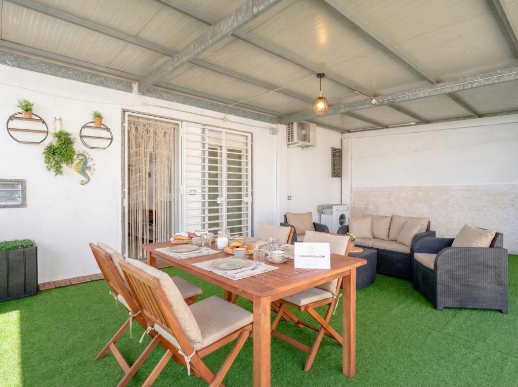a living room with a wooden table and a couch at CarmenLeo-Central Accommodation with Patio in Polignano a Mare