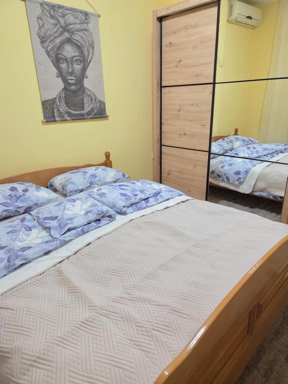 a bedroom with a large bed and a dresser at Cosy Apartment in Podgorica - Fast WiFi & cable TV in Konik