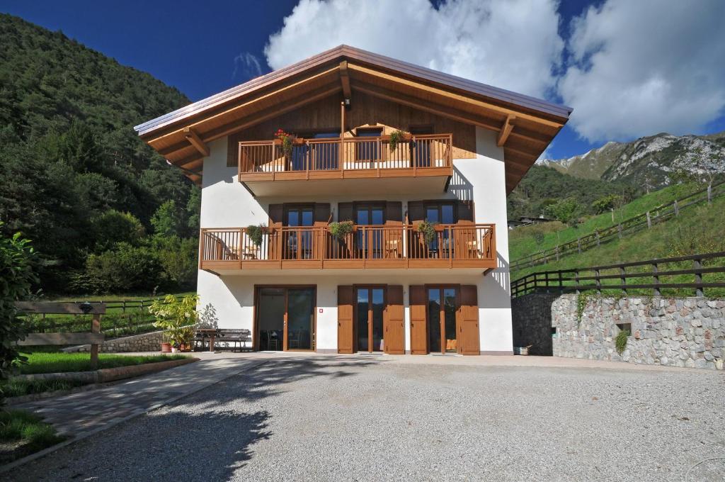 a large house with a balcony on top of it at B&B Ledro AFFITTACAMERE in Mezzolago