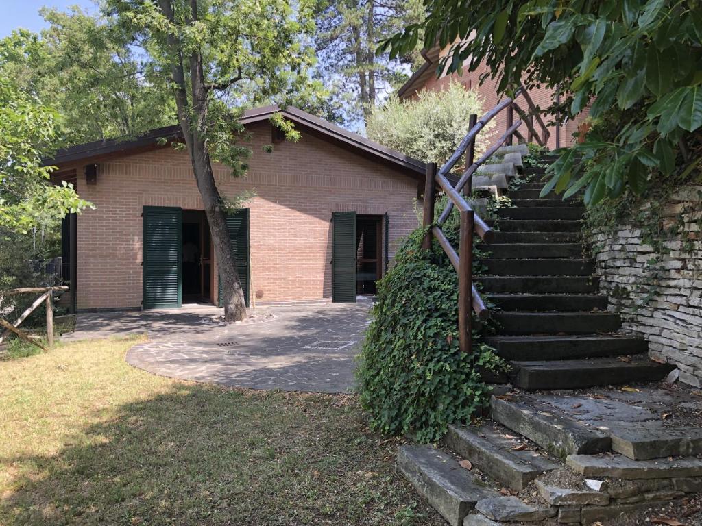 a brick building with stairs in front of it at B&B La Collina degli Ulivi in Zola Predosa