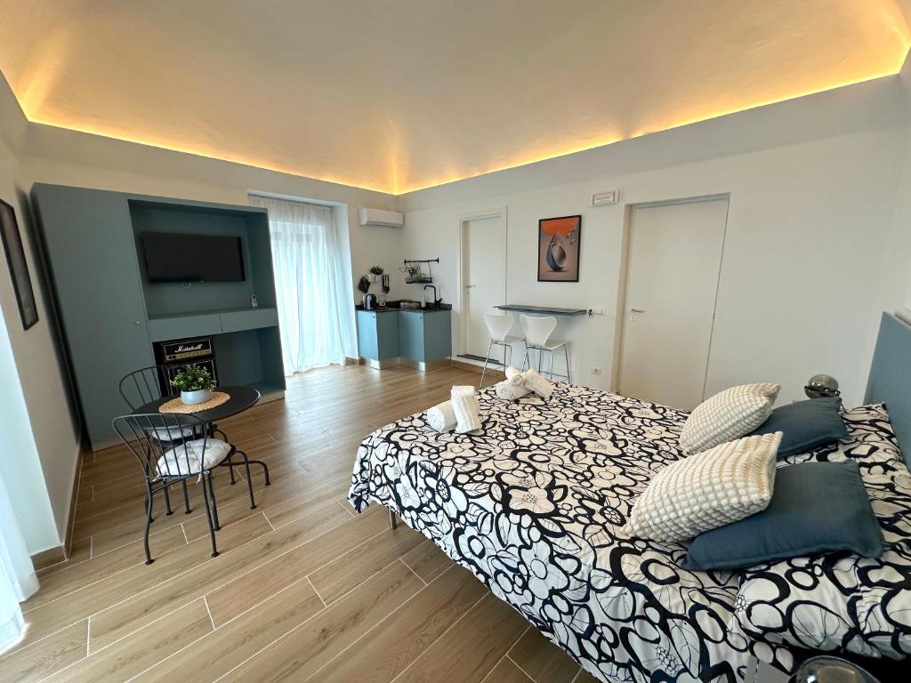 a bedroom with a bed and a living room at Umbrella Street Home in Catania