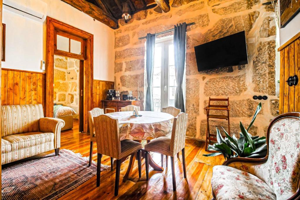 a living room with a table and chairs at Casa da Avó Selene - Refúgio Rústico e Exclusivo no Douro in Favaios