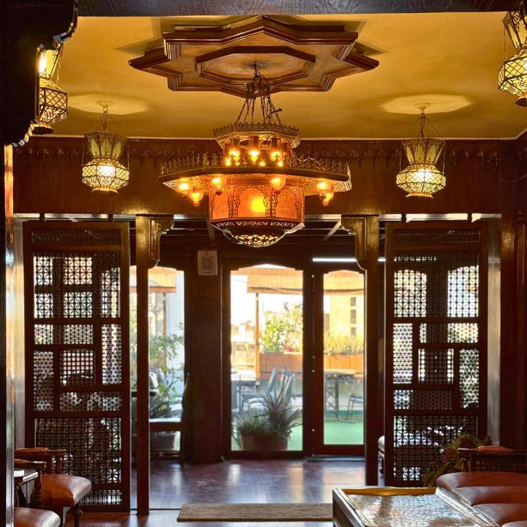 a lobby with chandeliers and doors to a patio at Odeon Palace Hotel in Cairo