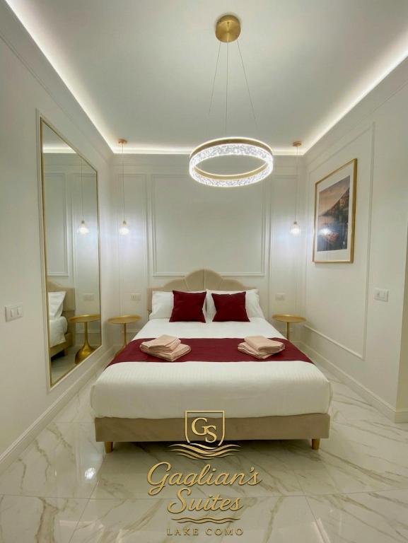 a bedroom with a bed and a chandelier at Gaglian's Suites Lake Como in Como