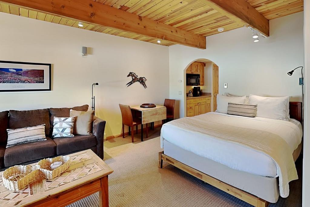 a bedroom with a bed and a couch and a table at Timberline Condominiums Studio Deluxe Unit 215 in Snowmass Village