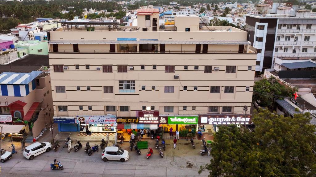 an overhead view of a building in a city at Hotel BMR Stay in Pollāchi