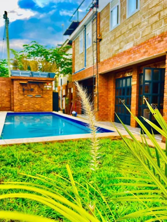 a swimming pool in the yard of a house at Jabulani Moshi in Msaranga
