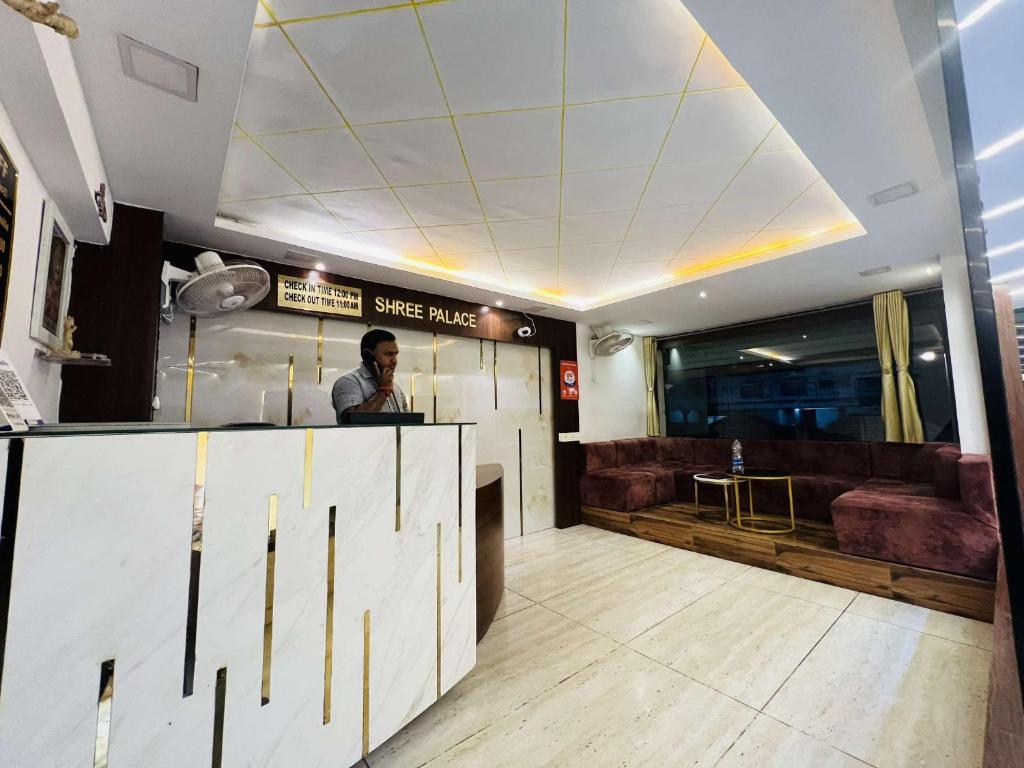 a man standing at a counter in a restaurant at hotel shree palace in Ratlām